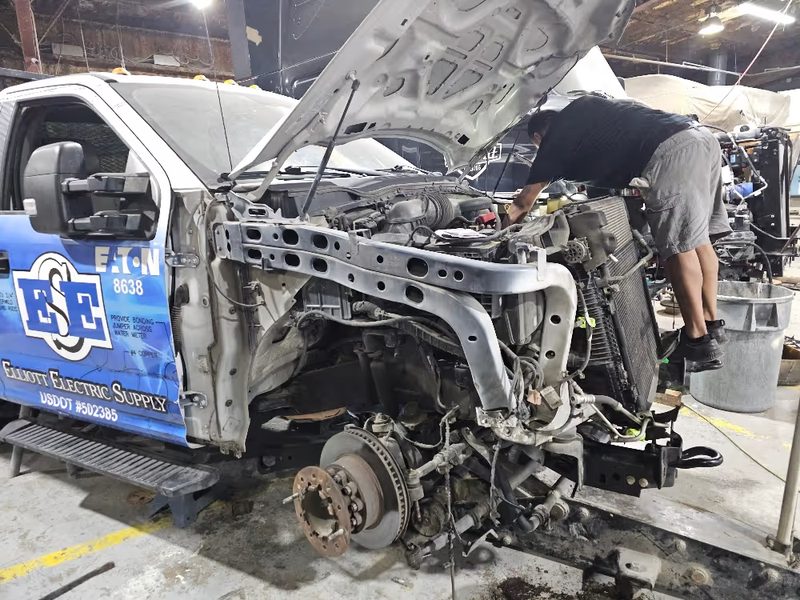 Work truck stripped to the rail so impact damage can be documented