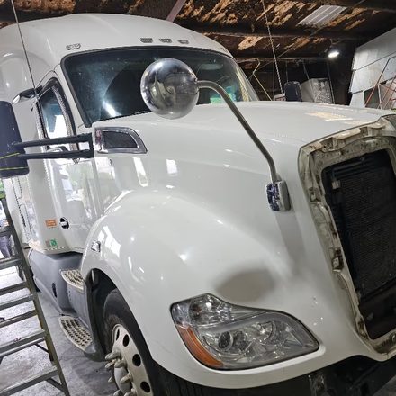White sleeper cab in the Dallas bay with the hood open