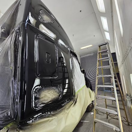 Black cab masked and glossed inside the paint booth